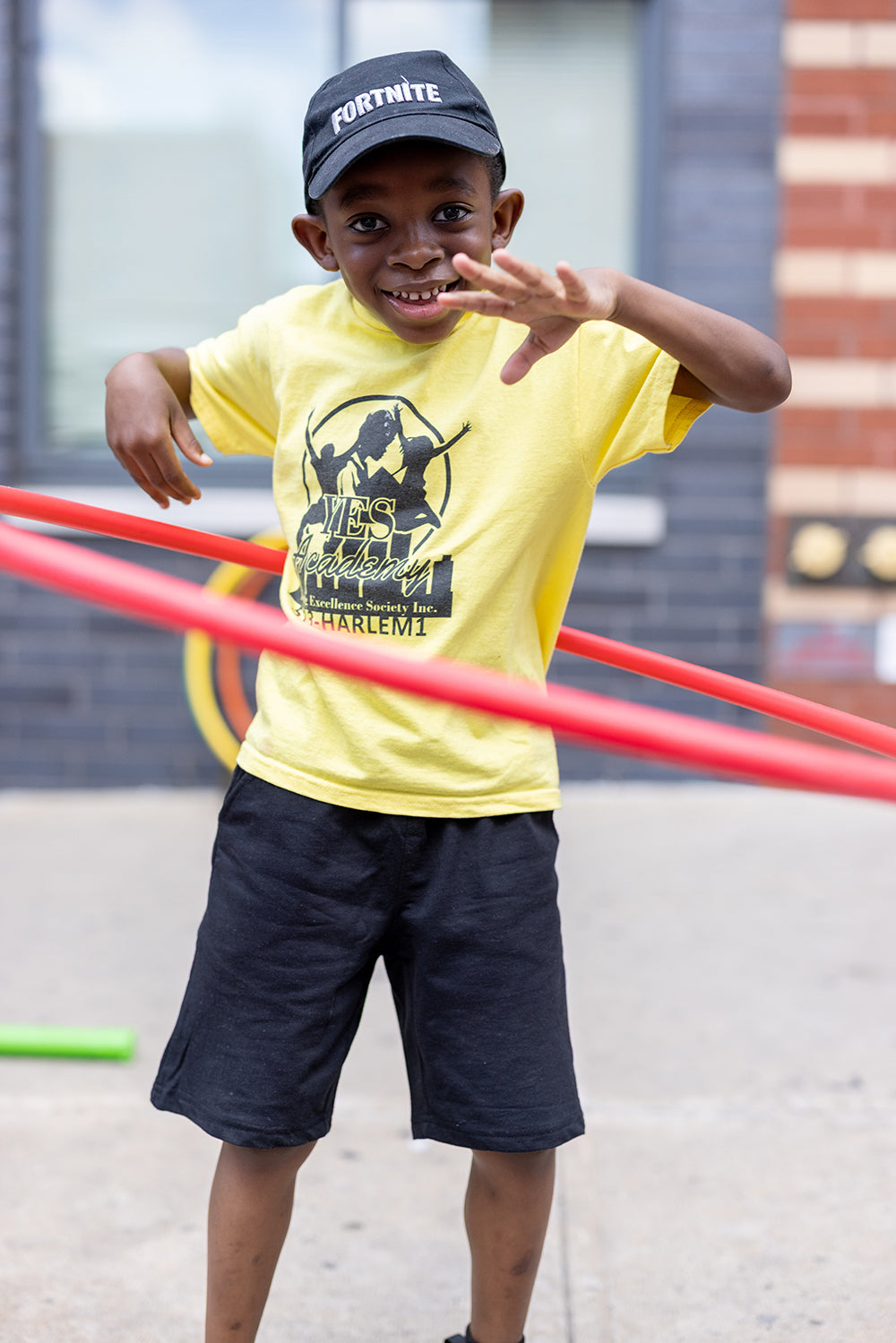 Harlem Mothers S.A.V.E. - little boy hula hooping in the street