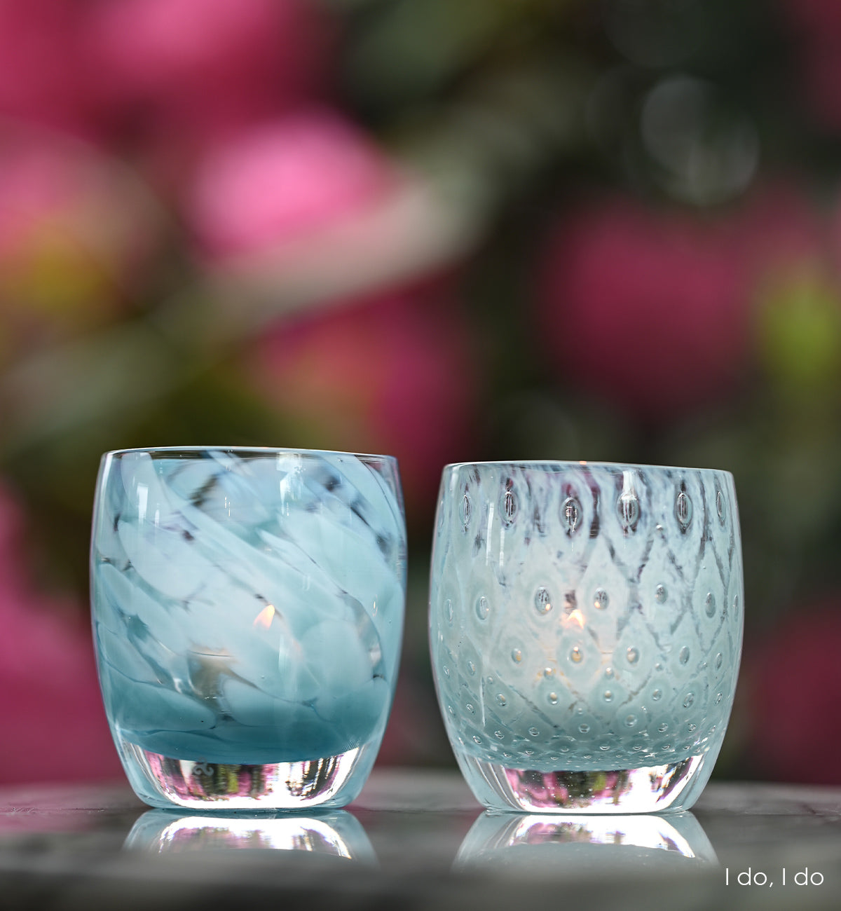 i do, i do is a set of two patterned light blue hand-blown glass candle holders. it includes good choice, a light blue bubble pattern and blessing a mottled blue pattern.