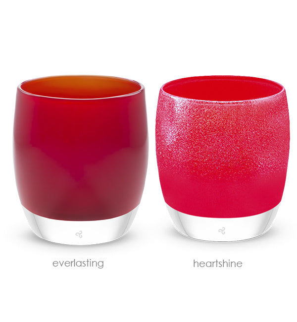 Two red glass candle holders labeled 'everlasting' and 'heartshine' on a white background