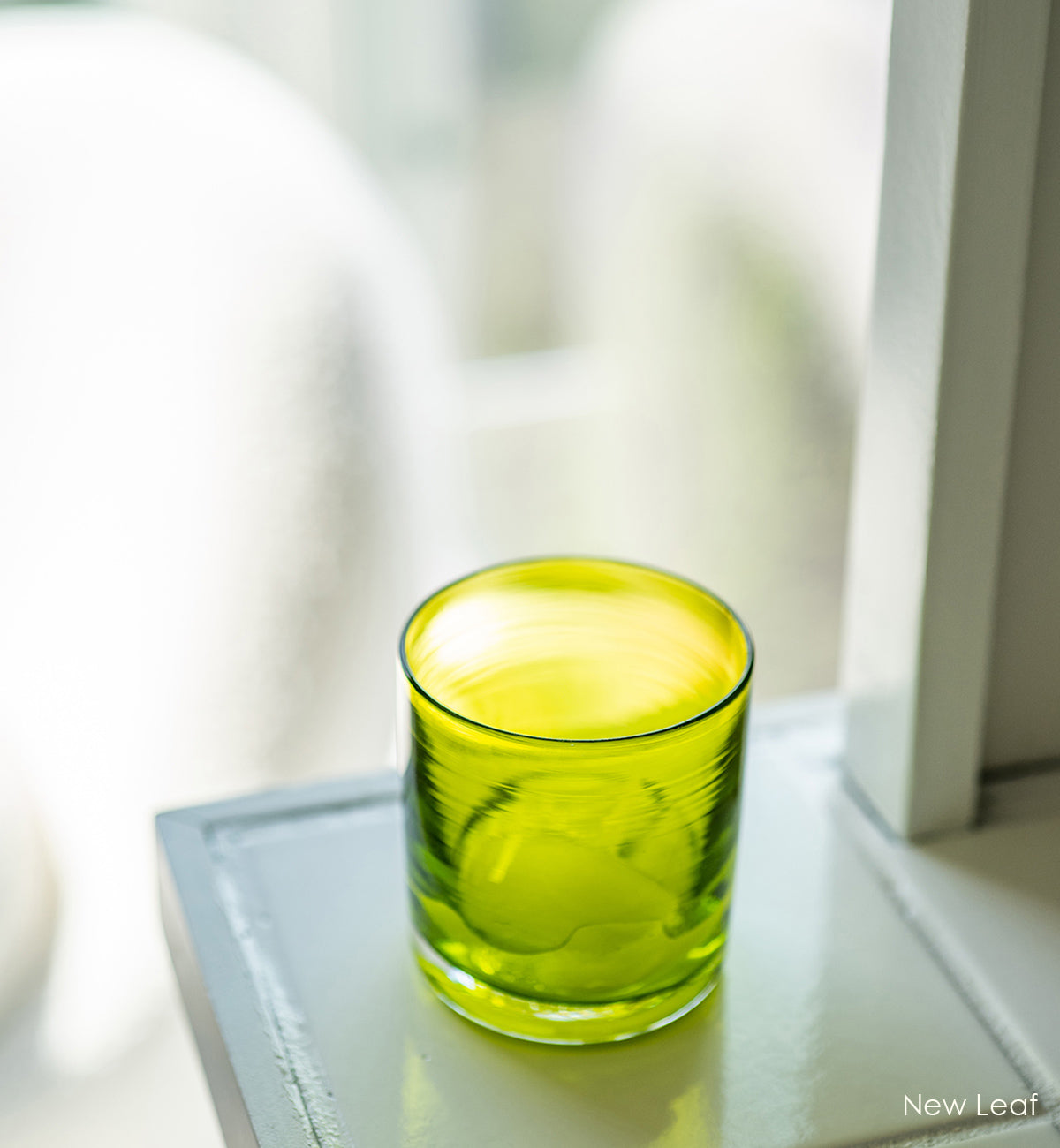 New Leaf rocker, translucent lime green hand-blown lowball glass, on a ceramic tile countertop.