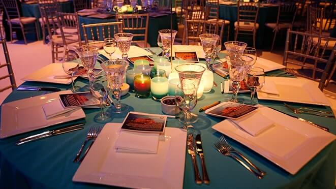 arrangement of blue glassybaby on banquet dining table