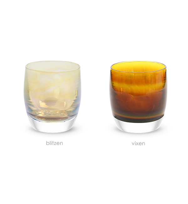 a set of iridescent brown and yellow translucent glassybaby candle holders. 'the reindeer', 'blitzen' and 'vixen' add a warm glow to any holiday occasion.