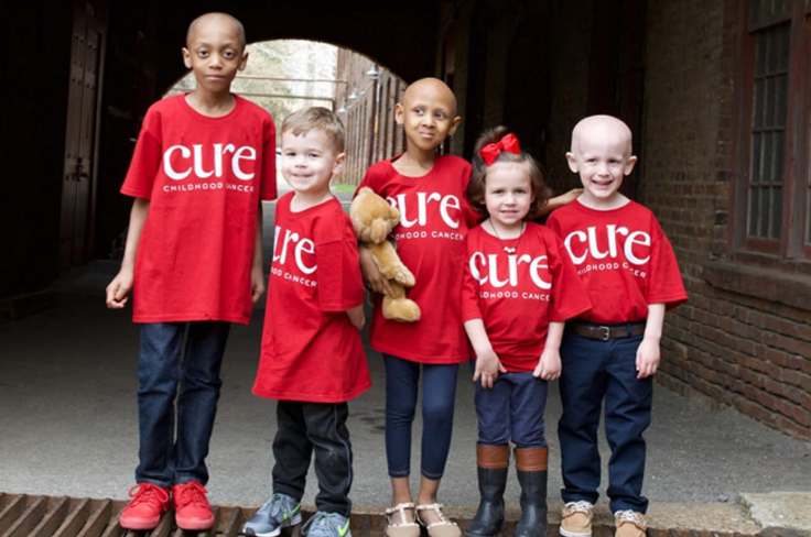 children wearing red "cure" shirts