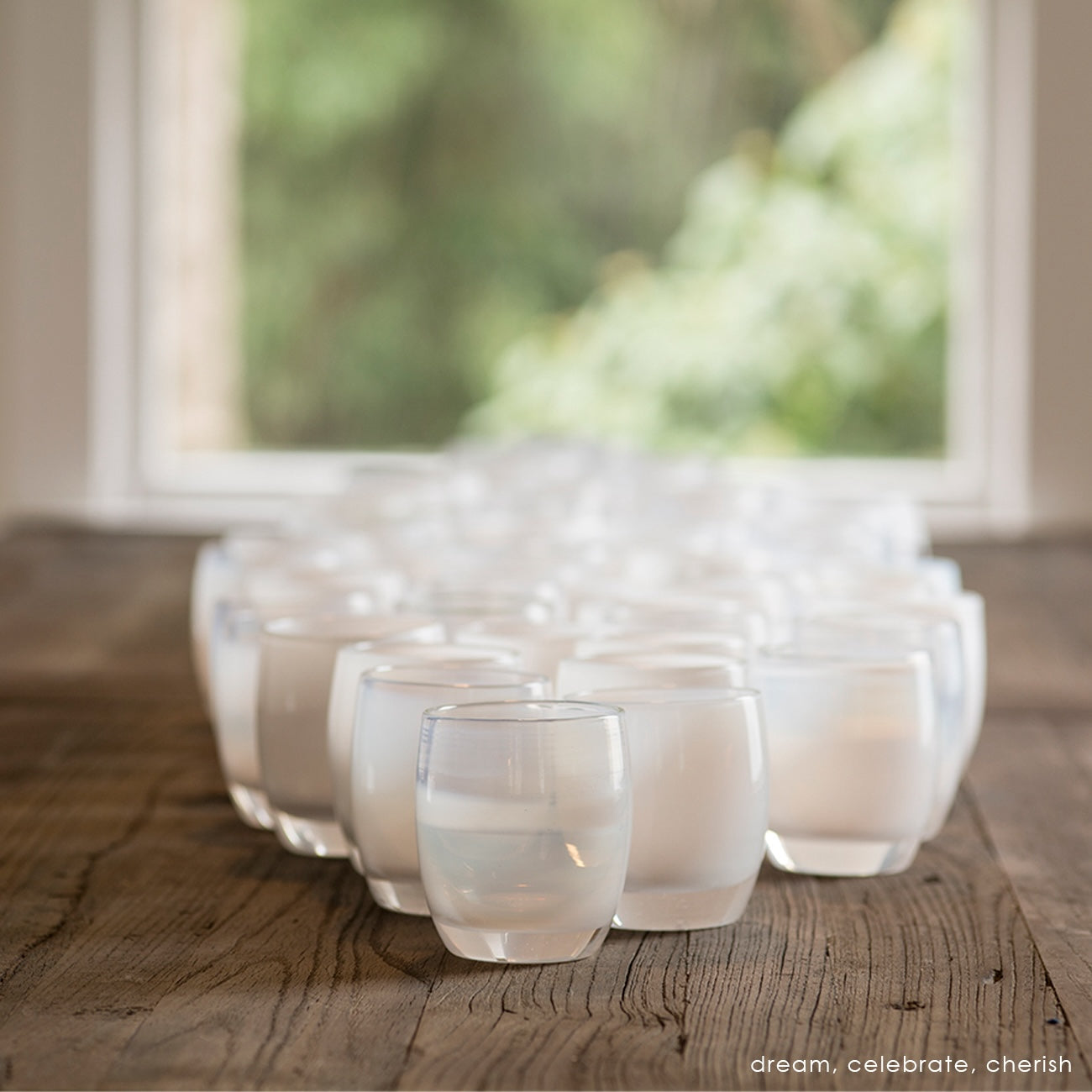 grouping of white hand-blown glass candle holders on table, dream celebrate and cherish