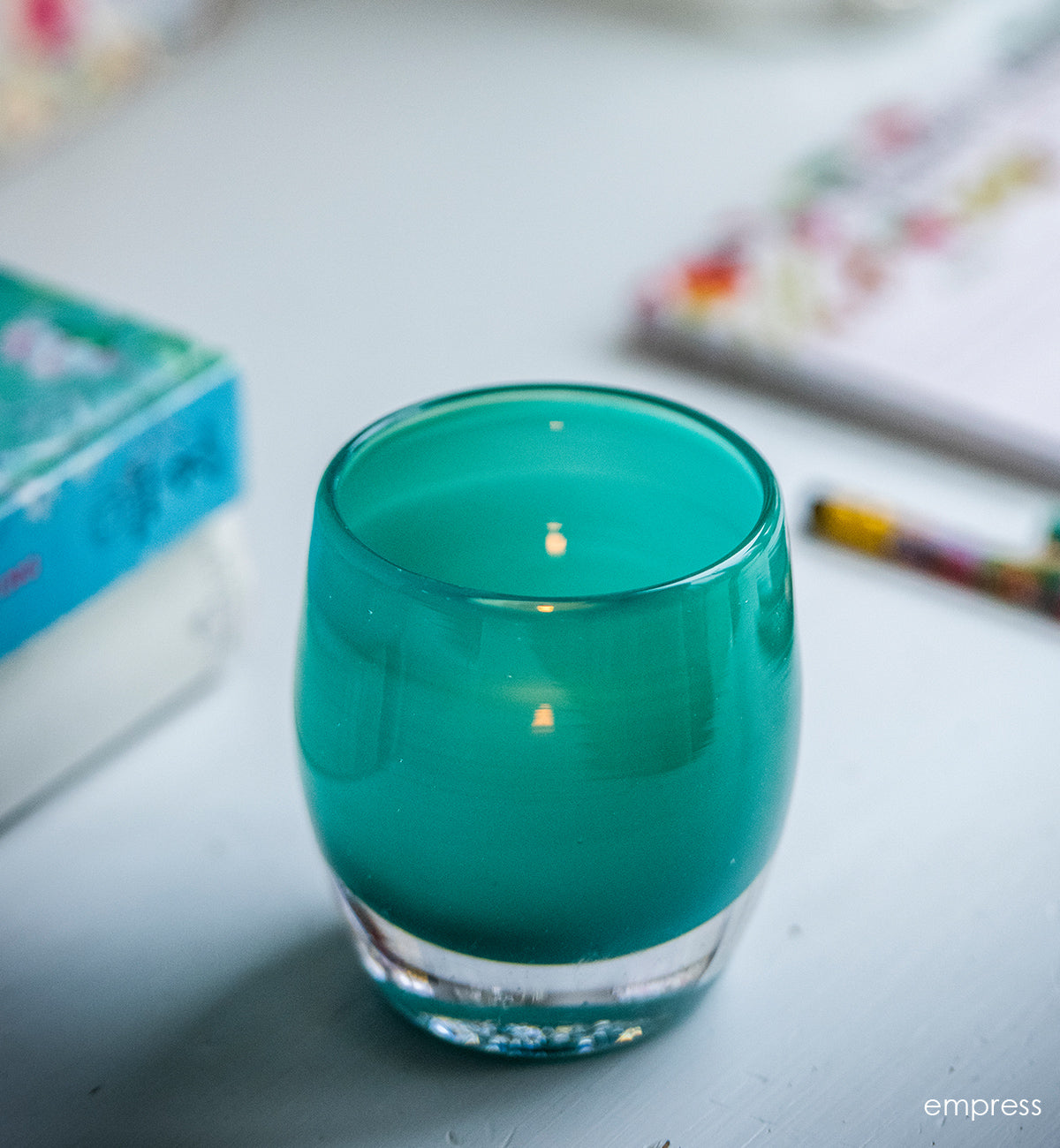empress is a beautiful elegant green, hand-blown glass votive candle holder.