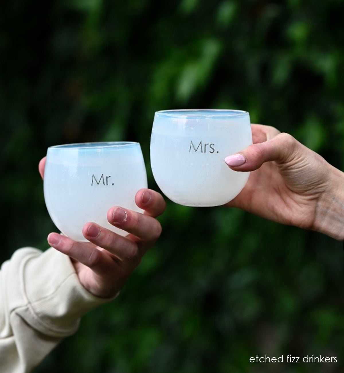 fizz white, hand-blown drinking glasses, etched with the word Mr. and Mrs.