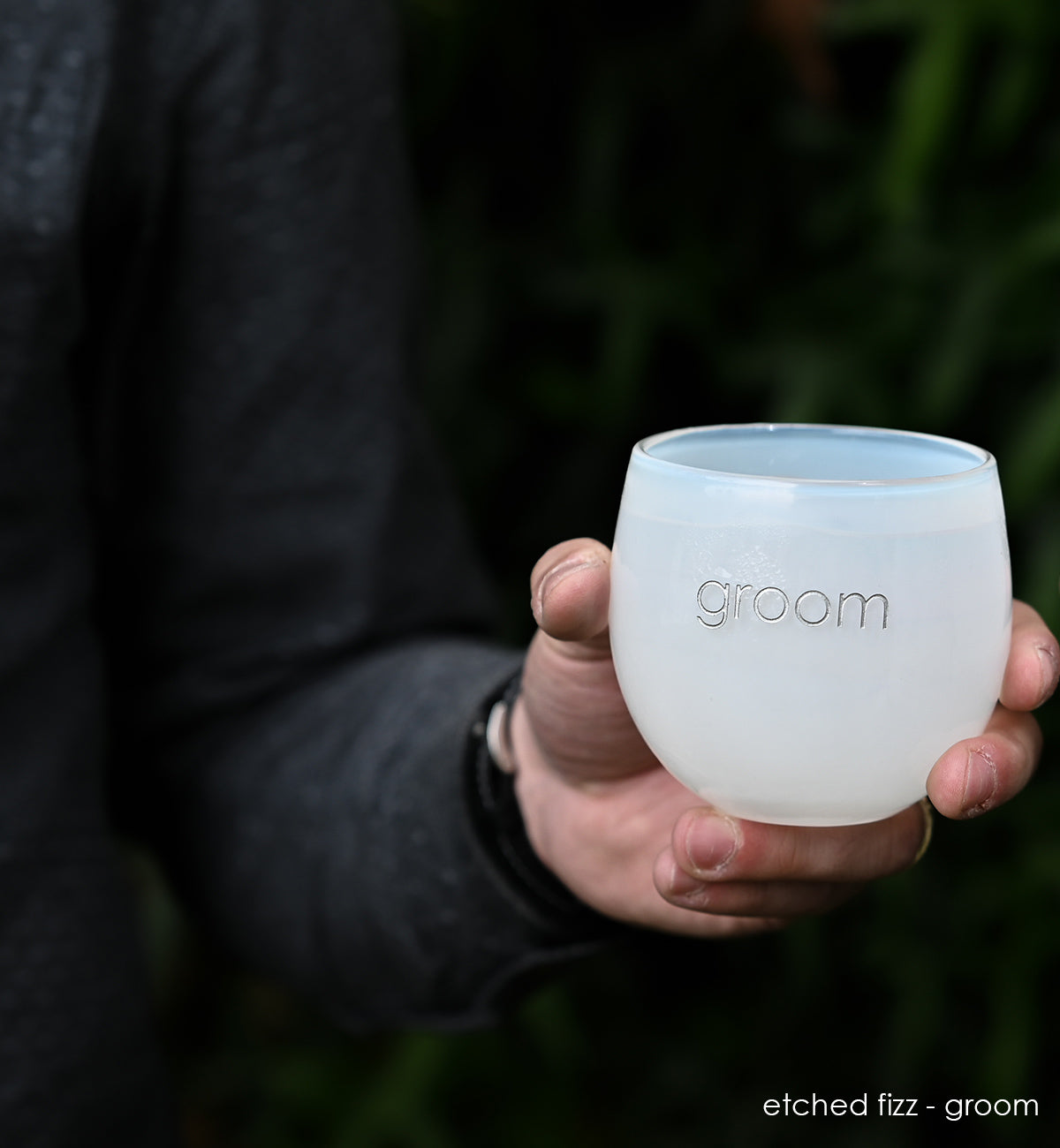 white hand-blown drinking glass etched with the word groom