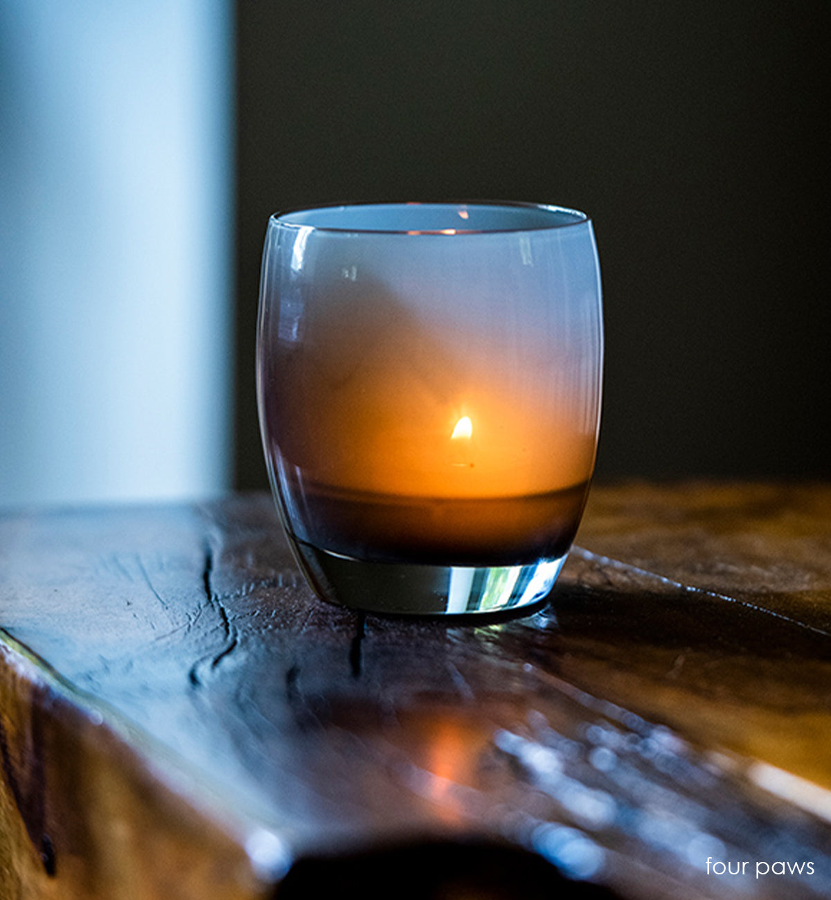four paws smokey gray hand-blown glass votive candle holder.