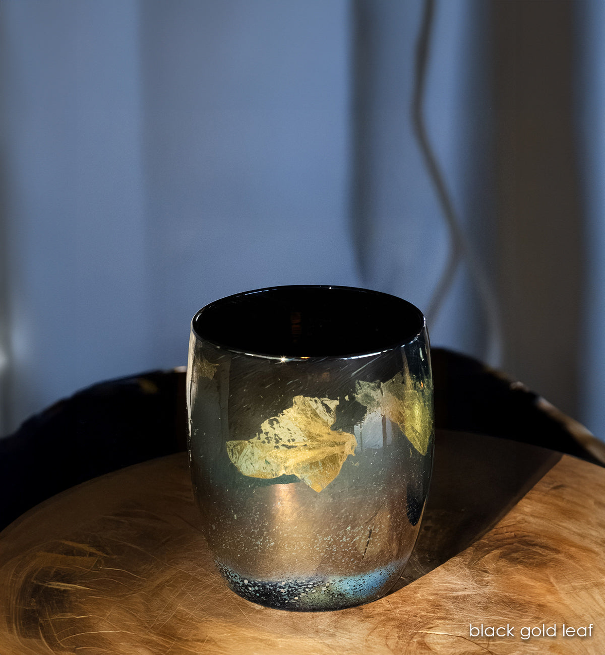 'black gold leaf', 14k gold leaf dancing across deep black glass handblown glass candle holder.