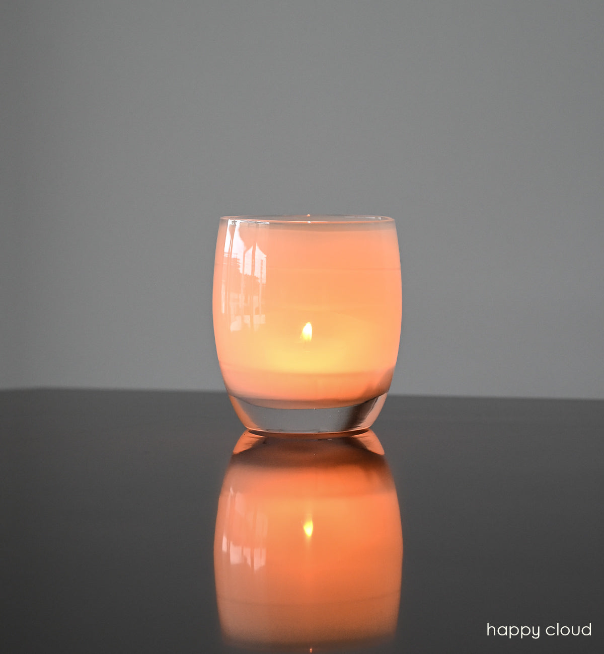 happy cloud light grey hand-blown glass votive candle holder.