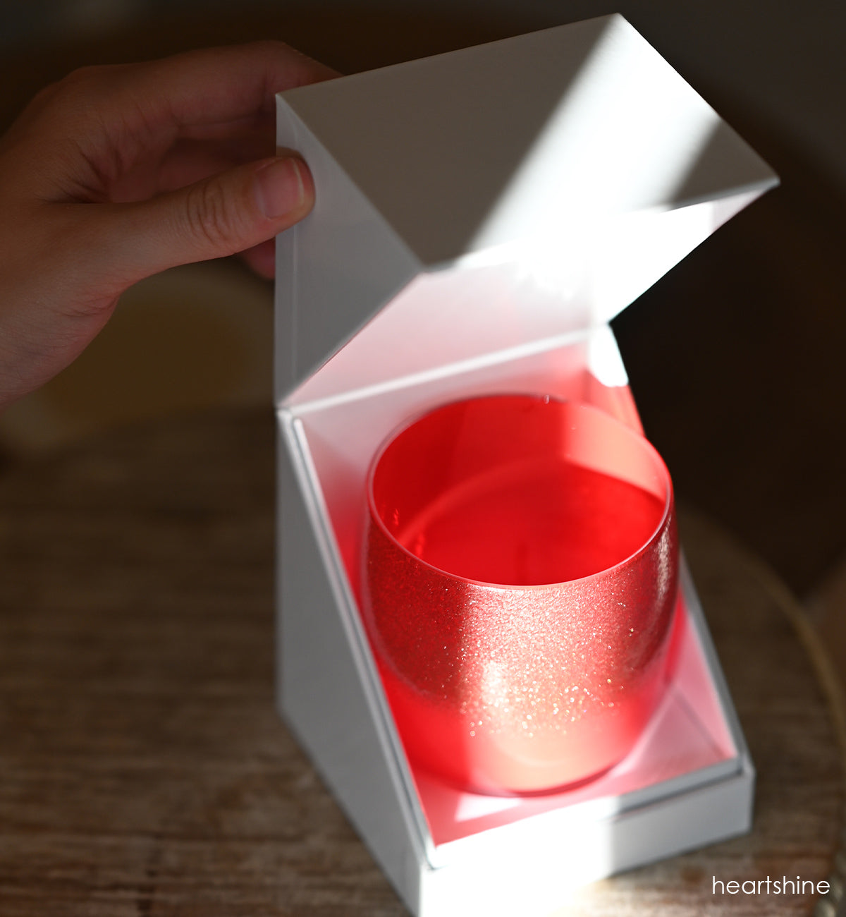 heartshine has a shimmering glitter that enrobes the top of a bright red base on this beautiful hand-blown candle holder.