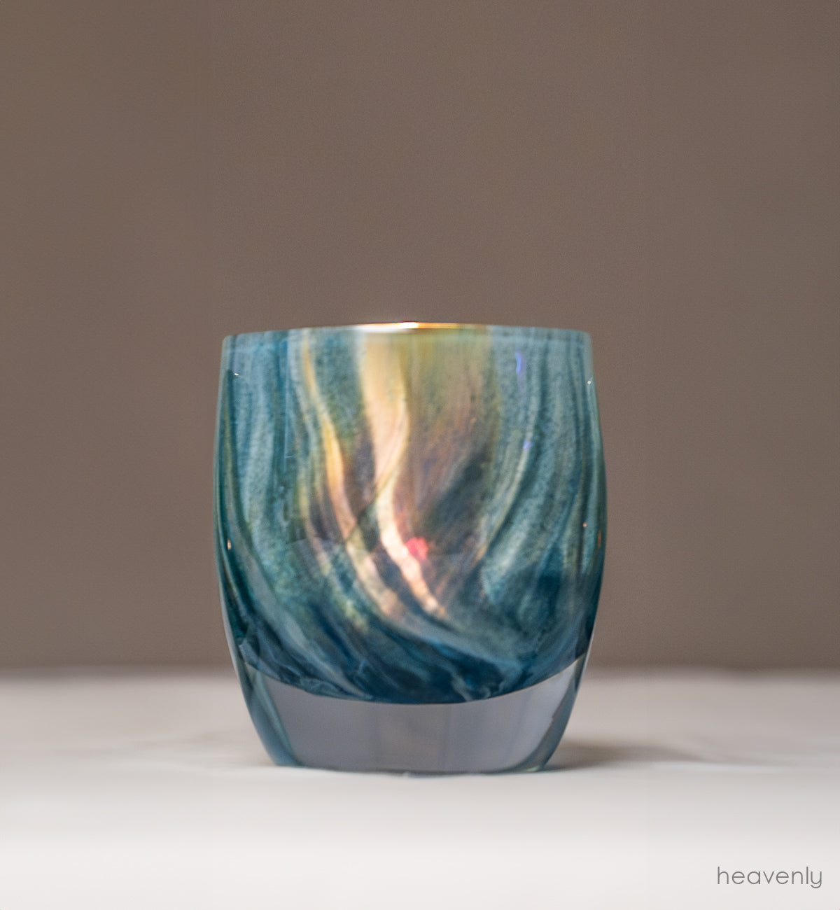 shimmering swirls of blue and green collide to create this ethereal hand-blown glass candle holder, heavenly.