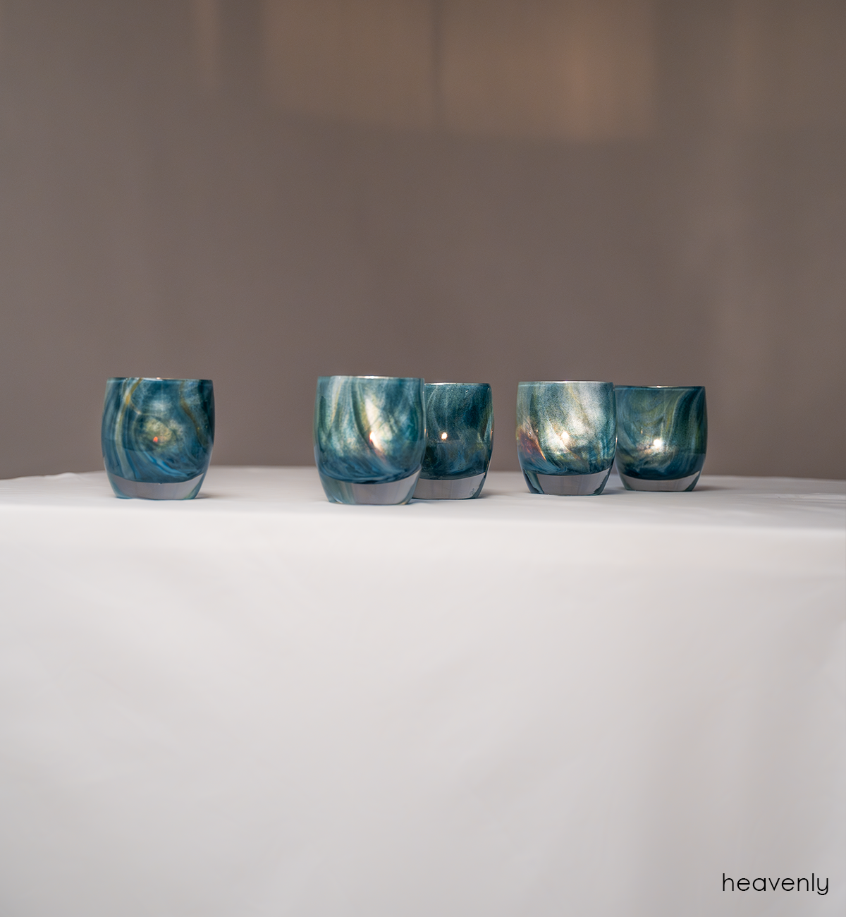 shimmering swirls of blue and green collide to create this ethereal hand-blown glass candle holder, heavenly.