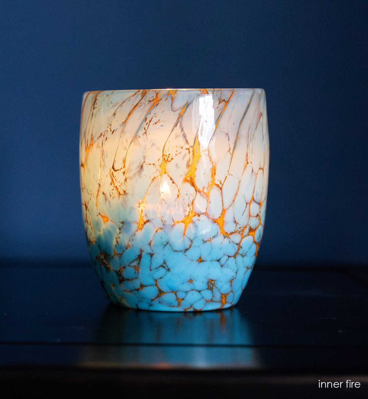 inner fire - turquoise hand-blown glass candle holder with blue background