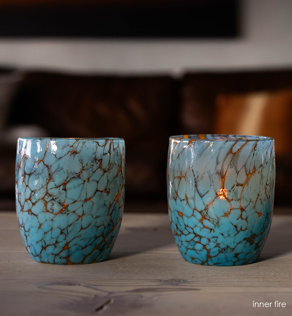 inner fire - turquoise hand-blown glass candle holders on wood coffee table