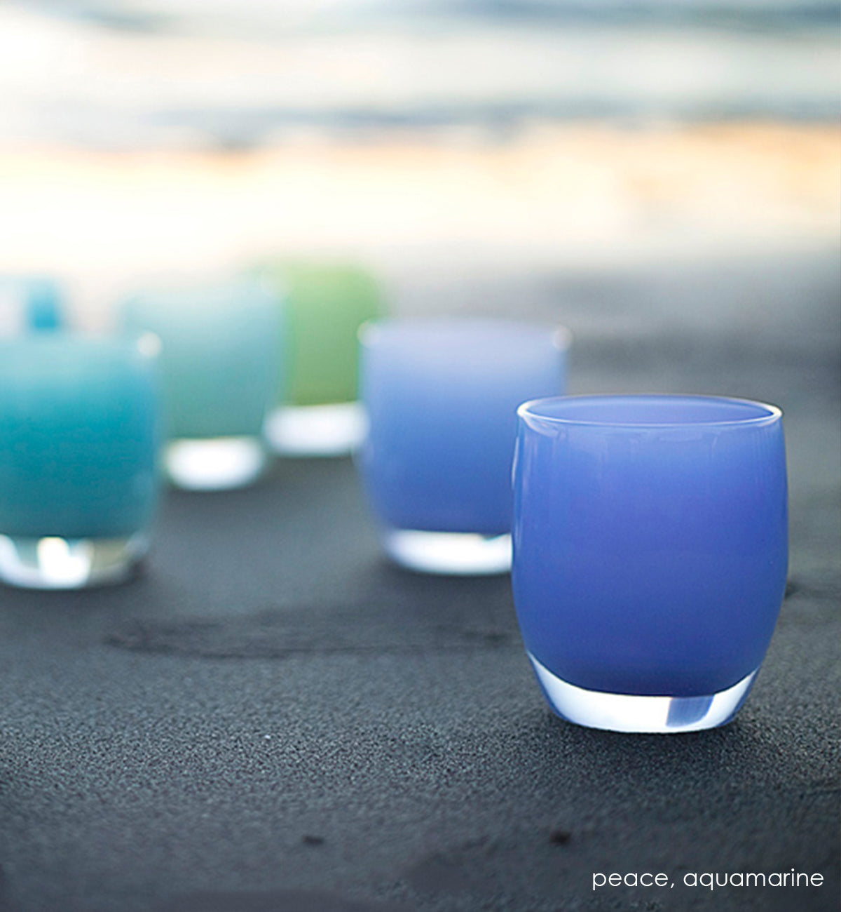 peace periwinkle blue hand-blown glass votive candle holder with aquamarine on the beach.