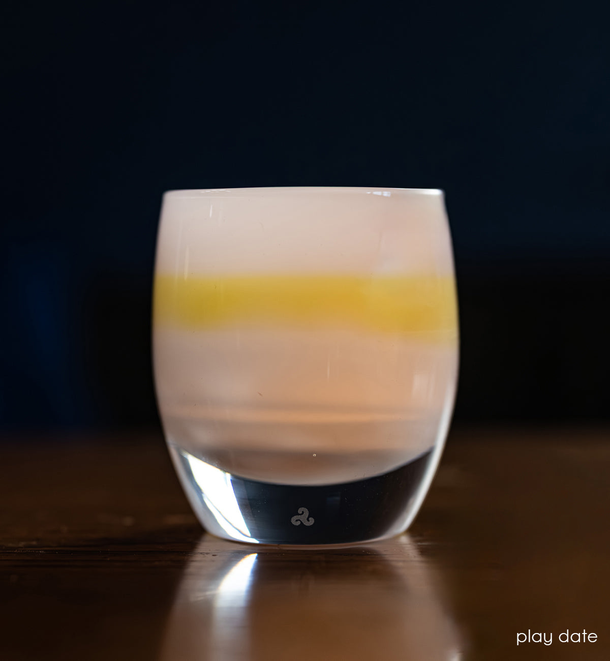 light blue and yellow chartreuse hand-crafted glass votive candle holder lit with dark blue background