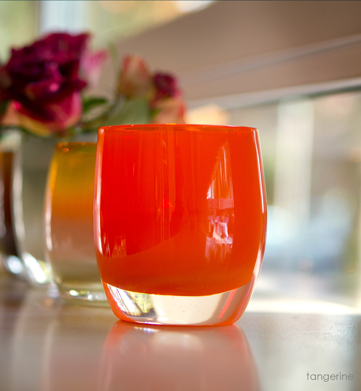 tangerine orange hand-blown glass votive candle holder.