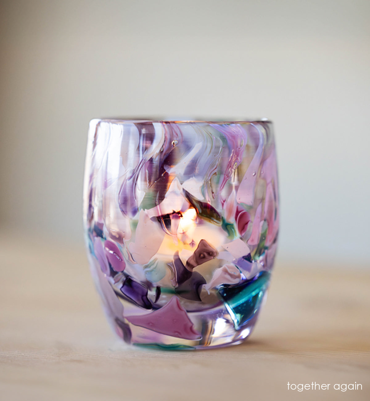 'together again' multi-color (blue, purple, brown, light blue) hand-blown glass candle holder cream background