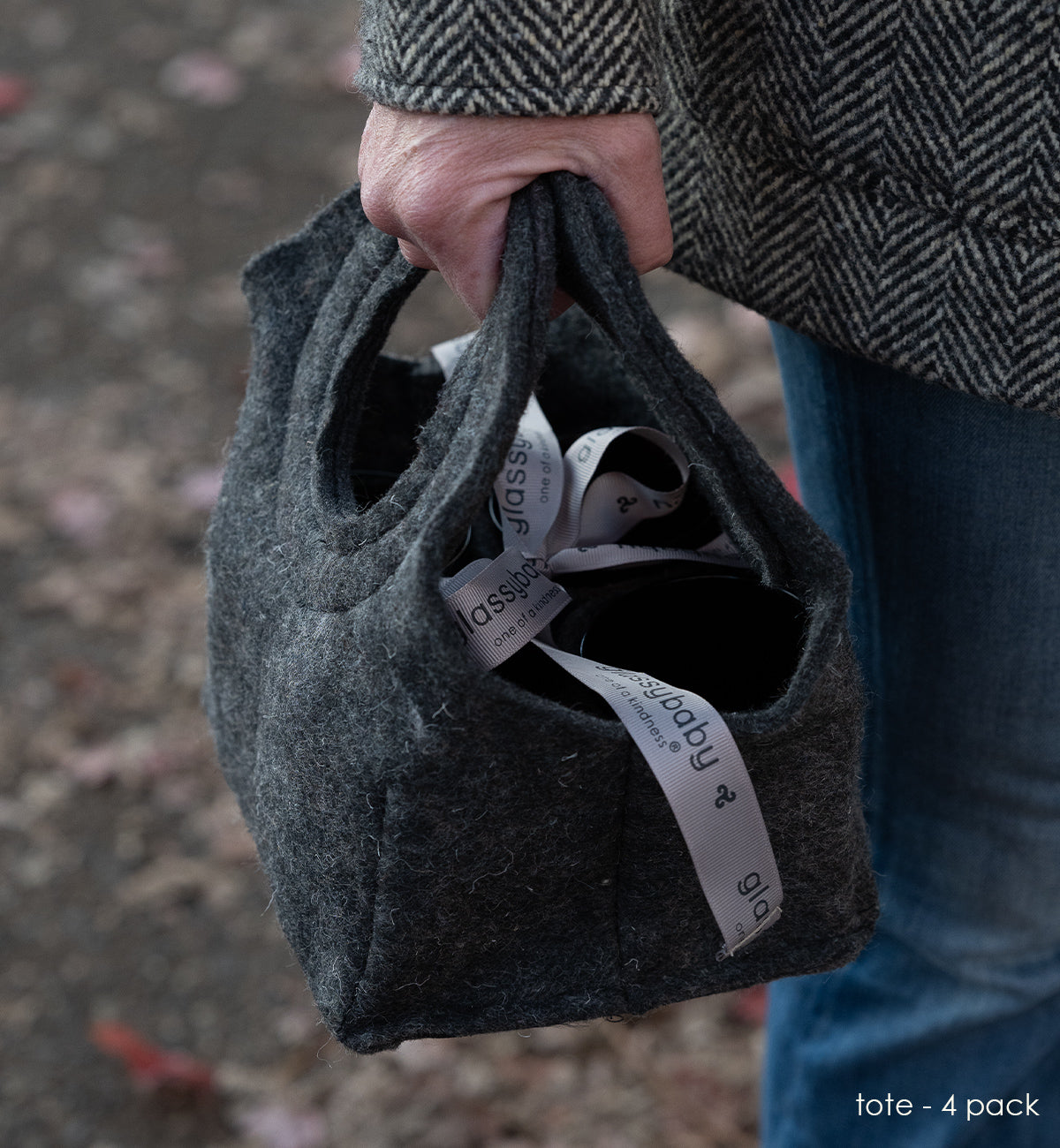 glassybaby felt tote being carried outdoors.