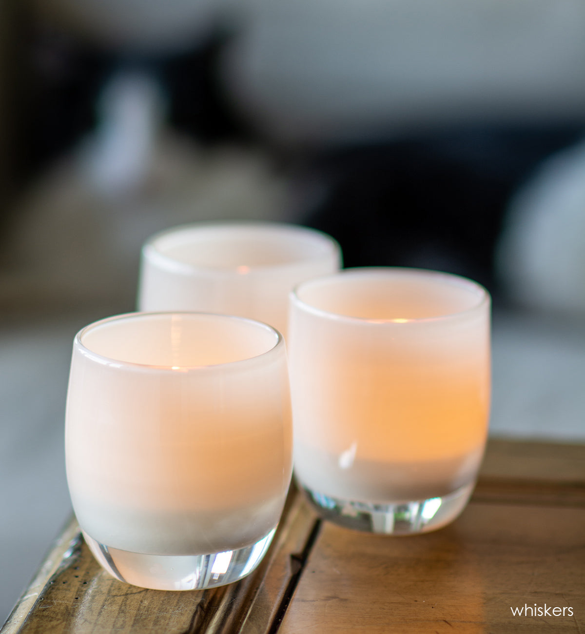 whiskers, opaque pale white, hand-blown glass votive candle holder.