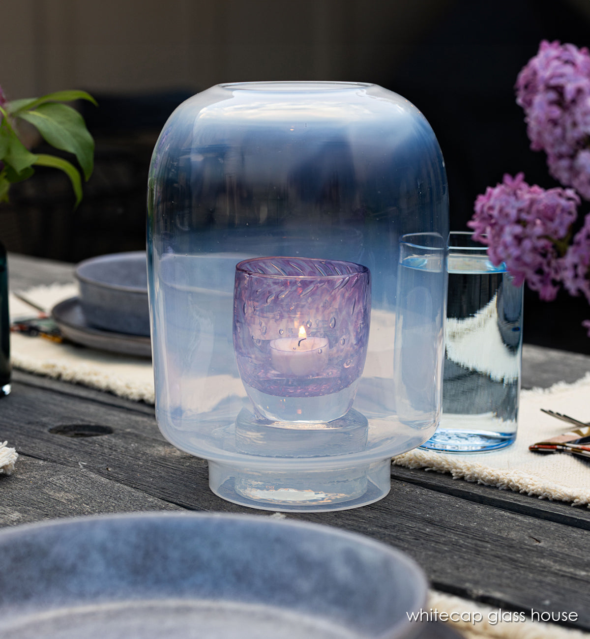 whitecap glass house, hand-blown glass hurricane one wood table with 'lady' glassybaby in it.