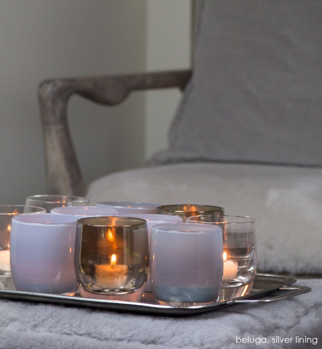 beluga light gray hand-blown glass votive candle holder. Paired with silver lining.