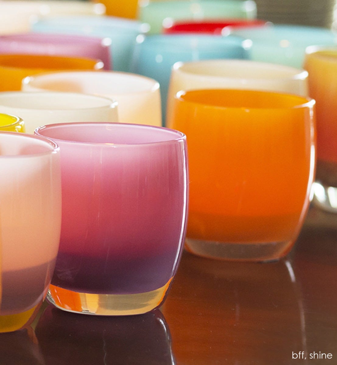 bff fuscia hand-blown glass votive candle holder with shine and other varying votives.