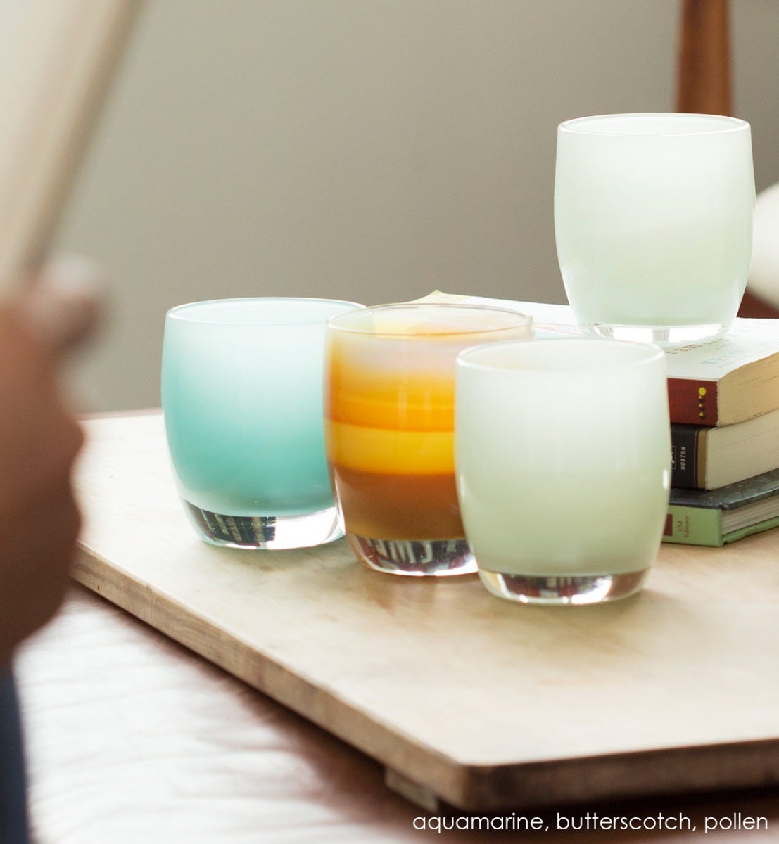 butterscotch hand-blown glass votive candle holder. Paired with aquamarine and pollen.