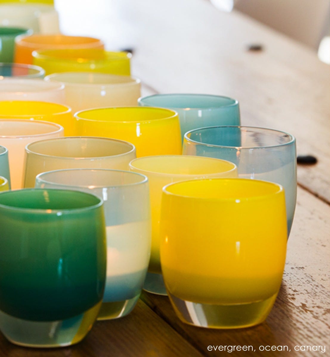 canary yellow hand-blown glass votive candle holder. Paired with evergreen and ocean.