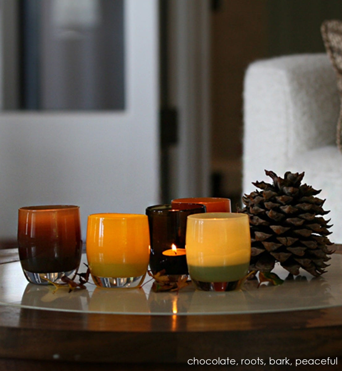 chocolate brown hand-blown glass votive candle holder. Paired with roots, bark, and peaceful.