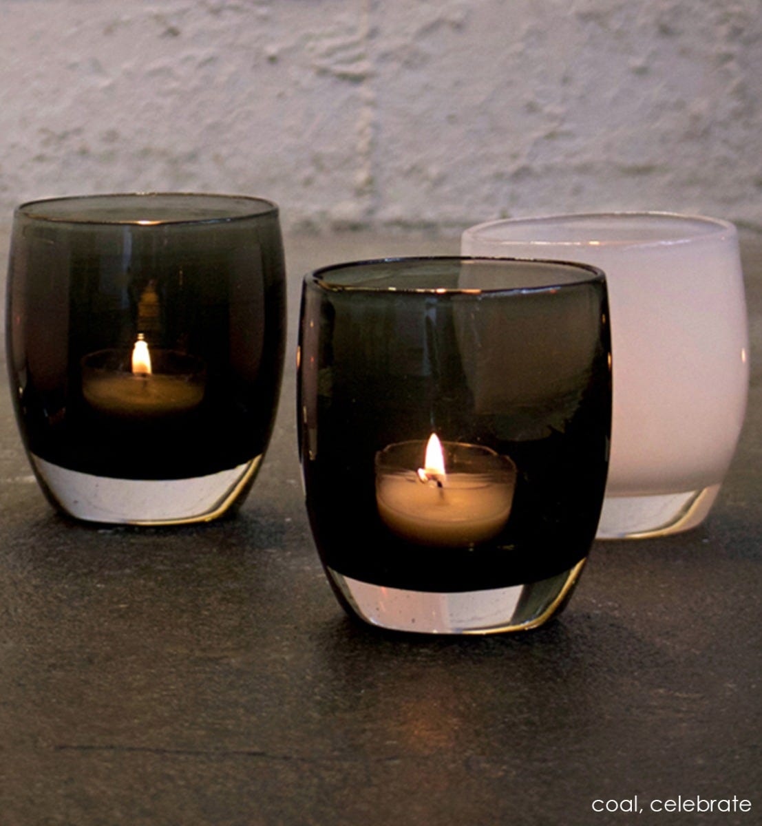 coal transparent black hand-blown glass votive candle holder. Paired with celebrate.