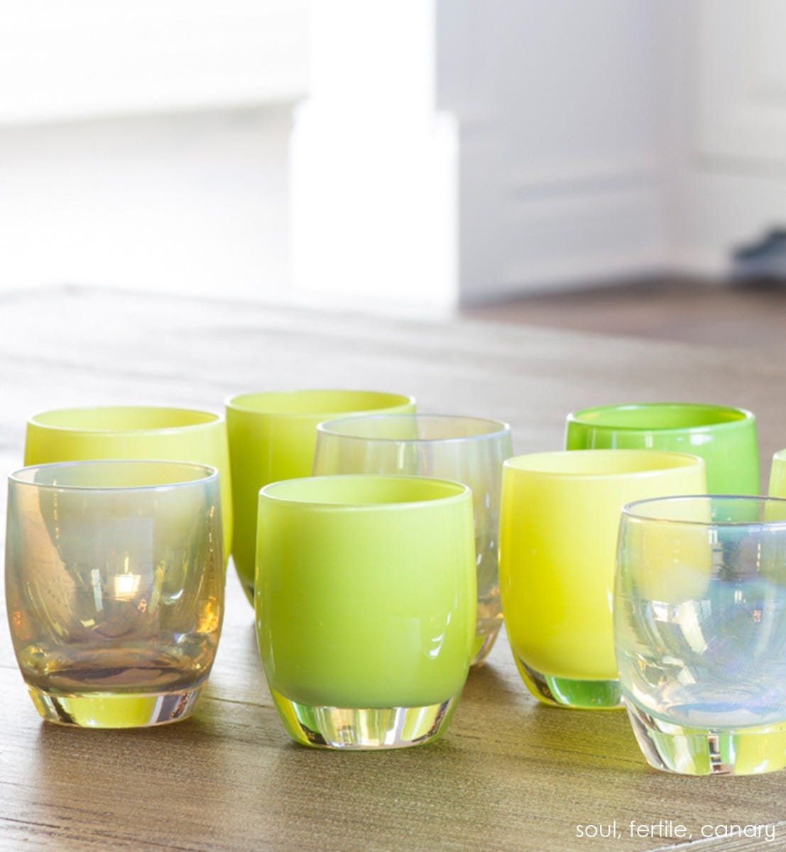 fertile patomic yellow green hand-blown glass votive candle holder. Paired with soul and canary along wooden steps.