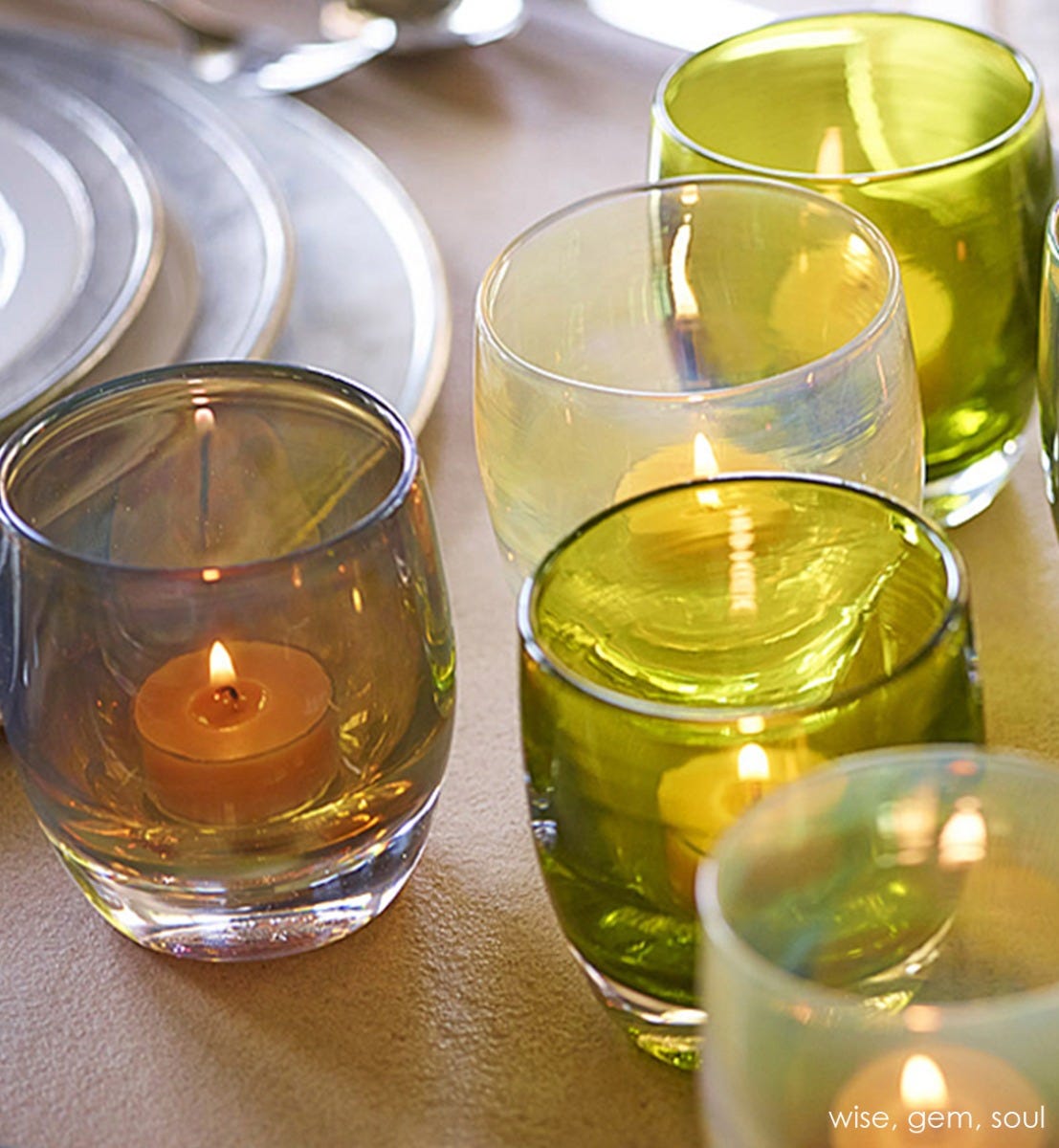 gem transparent green, hand-blown glass votive candle holder. Paired with wise and soul on dining table.