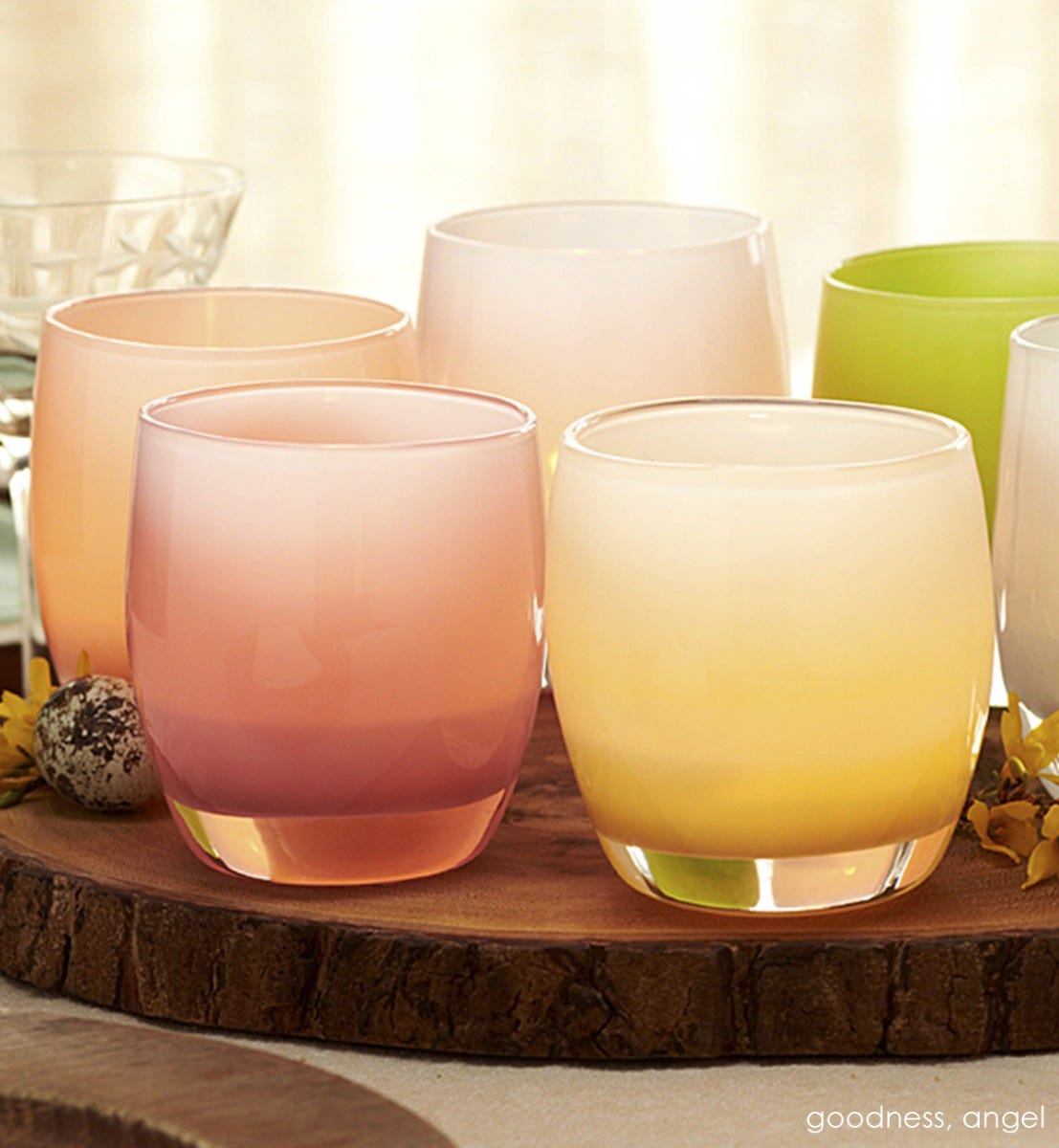 goodness opaque pink hand-blown glass votive candle holder. Paired with angel on a tree stump tray.