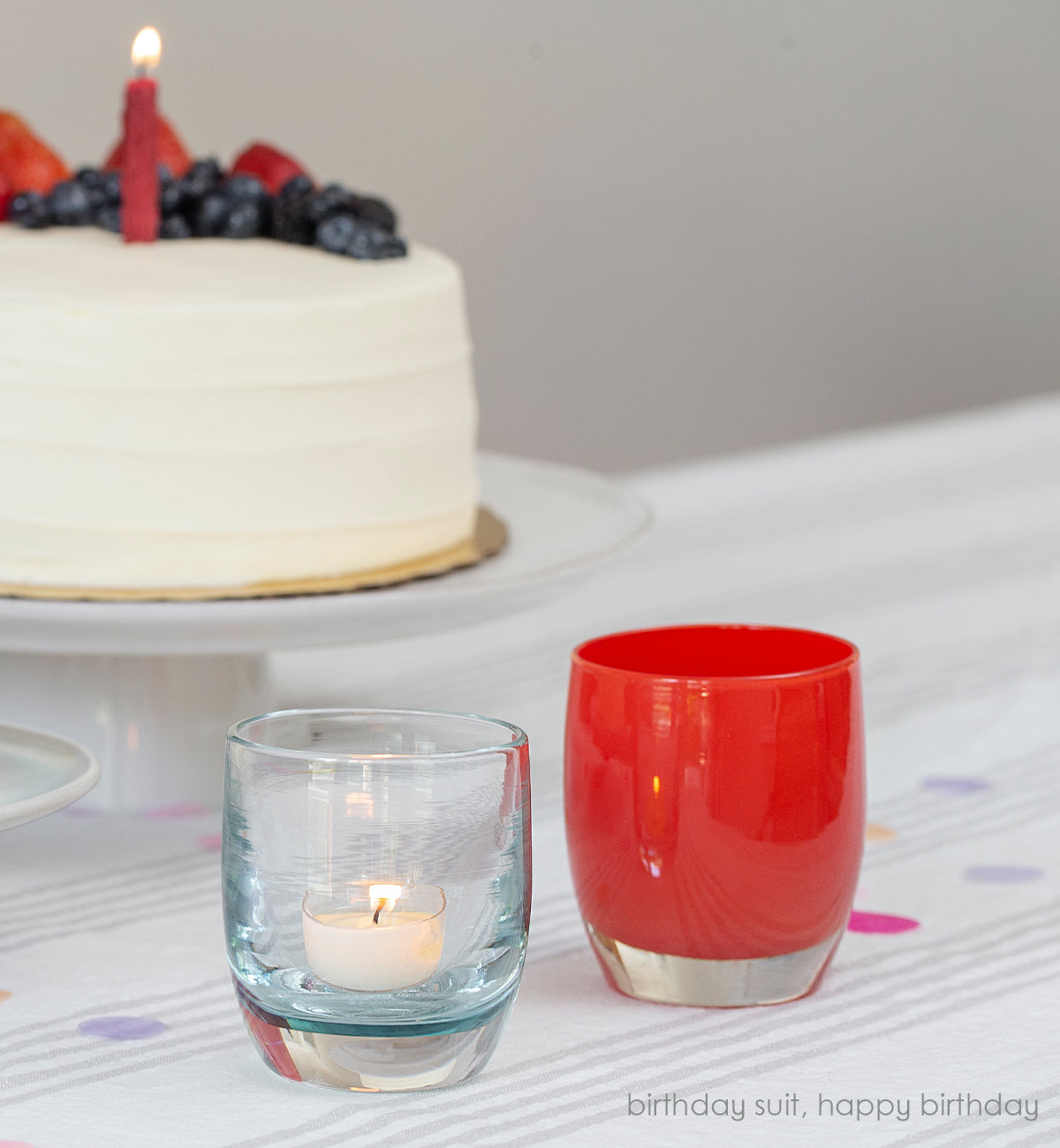 happy birthday bright red, hand-blown glass votive candle holder. Paired with birthday suit