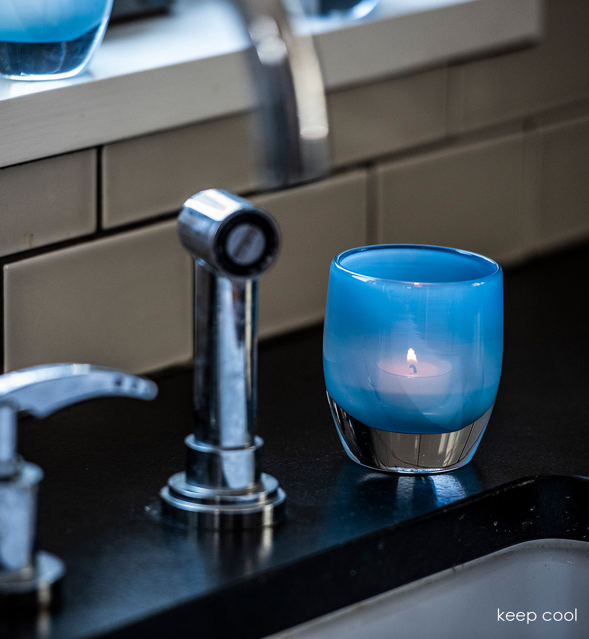 keep cool light blue hand-blown glass votive candle holder.