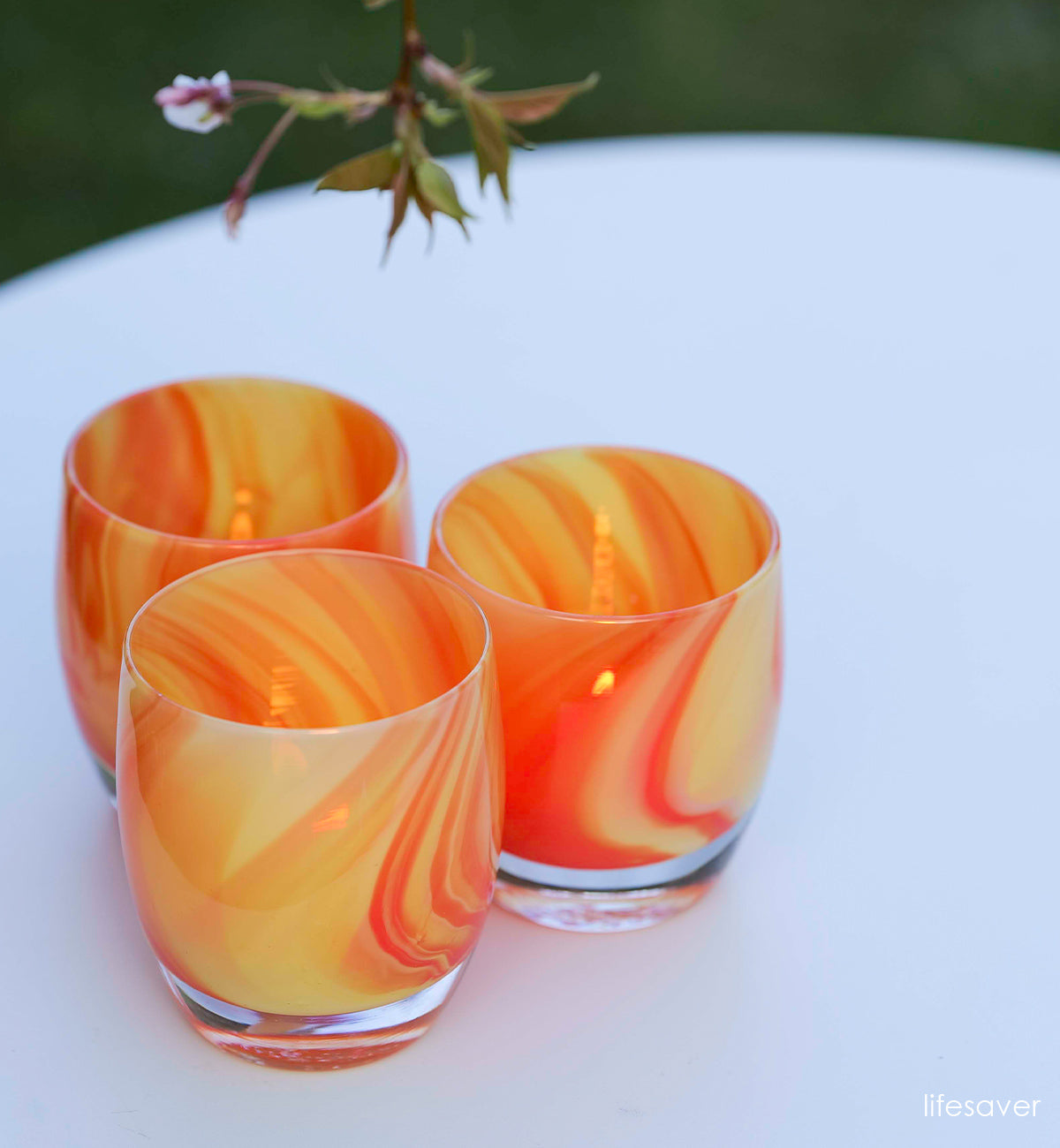 orange and yellow swirled hand-blown glass candle holder.