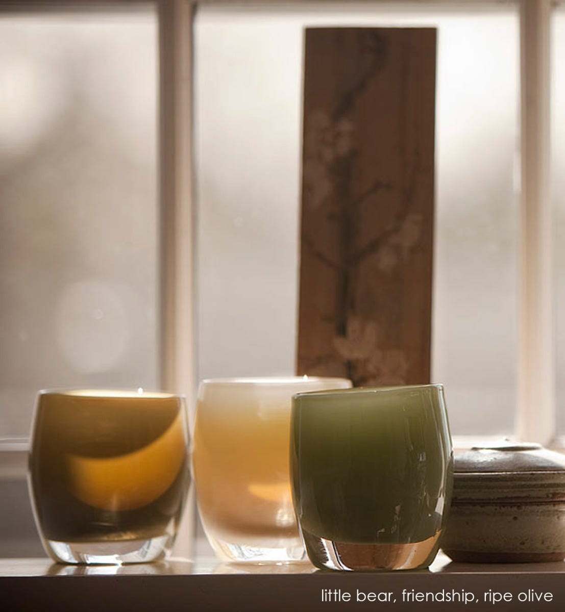 little bear deep brown hand-blown glass votive candle holder. Paired with friendship and ripe olive on a windowsill.