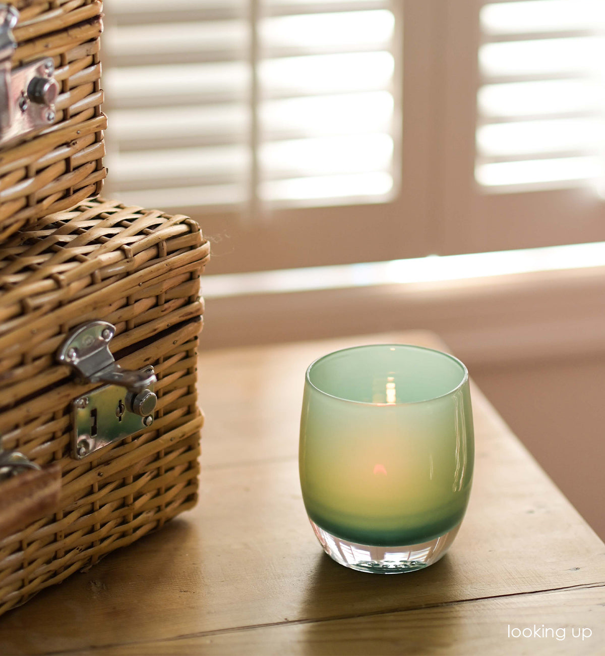 looking up aqua hand-blown glass votive candle holder.