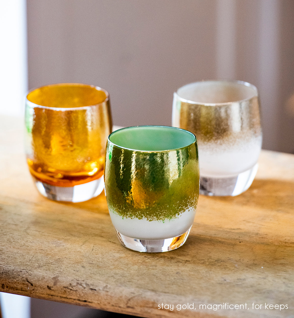 magnificent green and gold tones cover a white base, hand-blown glass candle holder.