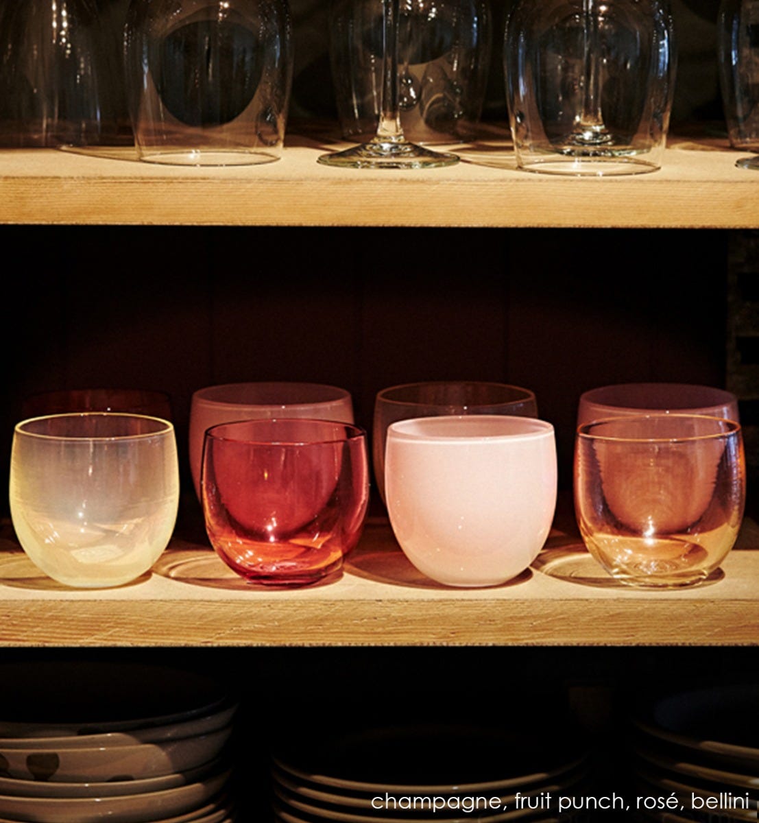 rosé drinker, soft pink hand-blown drinking glass on a kitchen shelf with champagne drinker, fruit punch drinker, and bellini drinker.