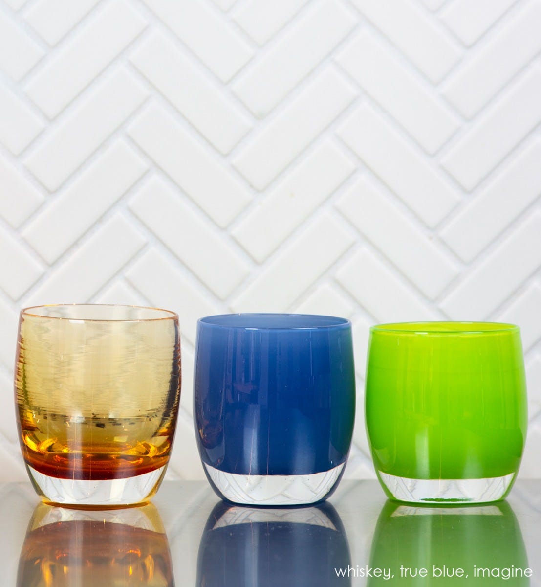 true blue stormy blue, hand-blown glass votive candle holder. Paired with whiskey and imagine.