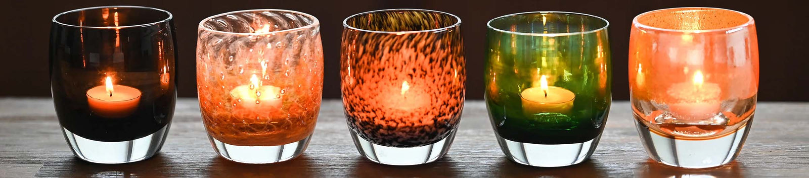 a fall collection of orange and black hand blown votives