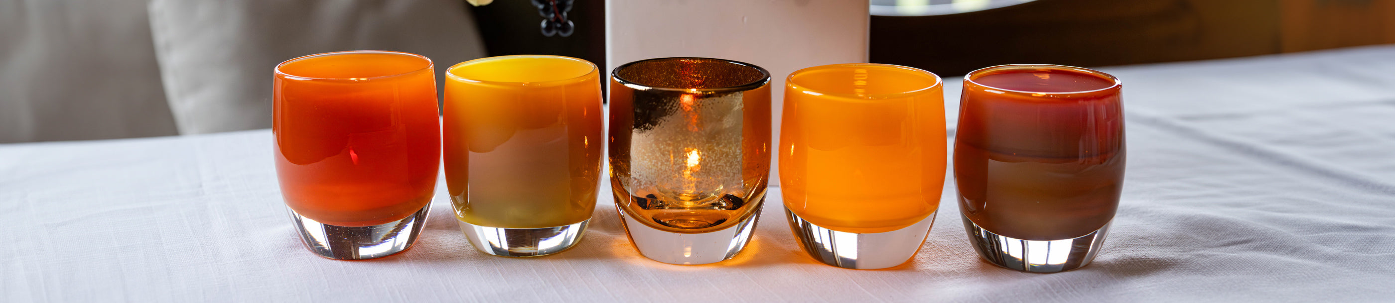 a fall collection of orange and black hand blown votives