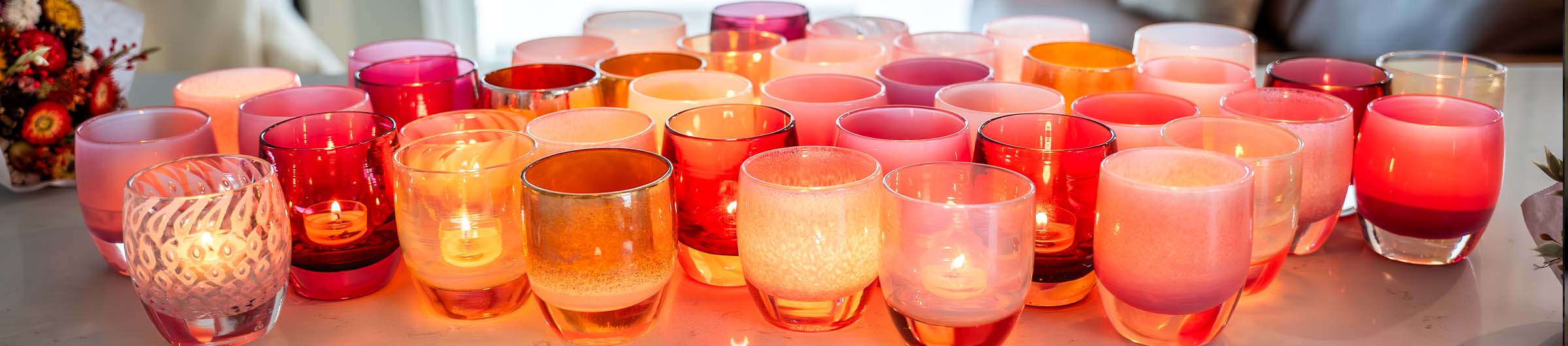 pink party collection, featuring a variety of pink hand-blown glass votive candle holders.