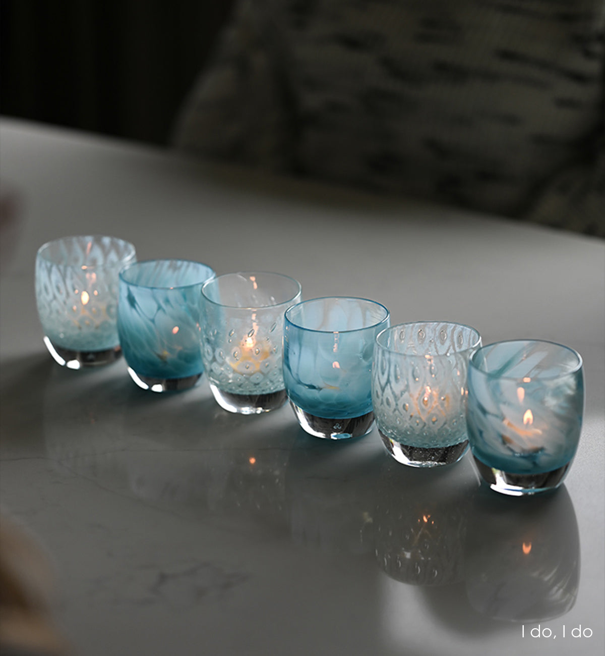 i do, i do is a set of two patterned light blue hand-blown glass votive candle holders. it includes good choice a light blue bubble pattern, and blessing a mottled blue pattern.