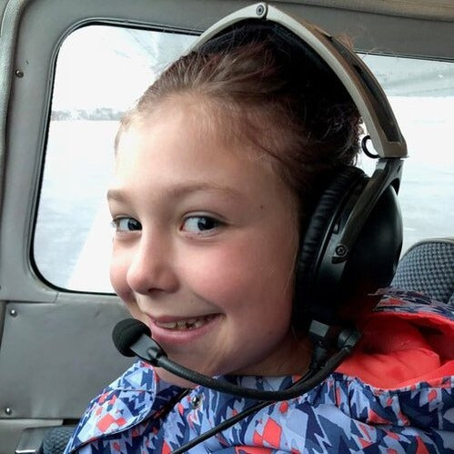 girl with headset in airplane
