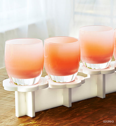 azalea light pink hand-blown glass votive candle holders on on white stand.