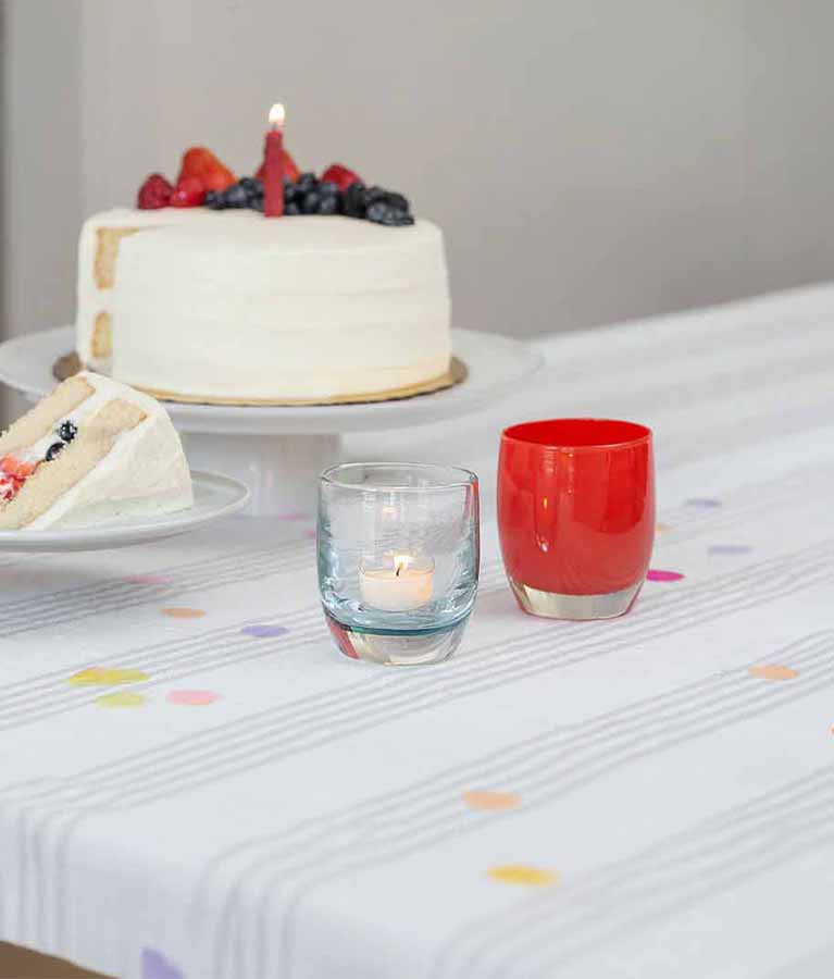 birthday celebration with hand-blown glass votive candle holders, birthday suit clear and happy birthday red.